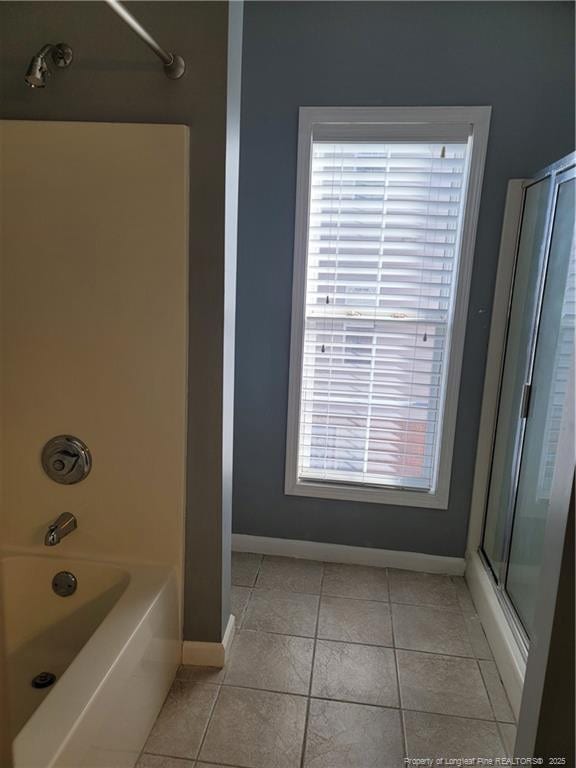 bathroom with tile patterned flooring and a wealth of natural light