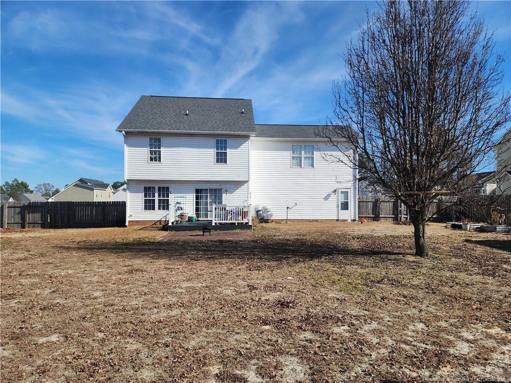 back of house with a lawn