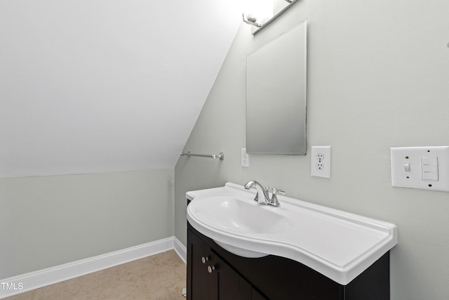 bathroom with vanity and lofted ceiling