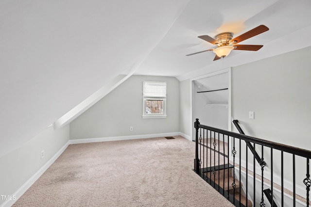 bonus room featuring vaulted ceiling, carpet, and ceiling fan