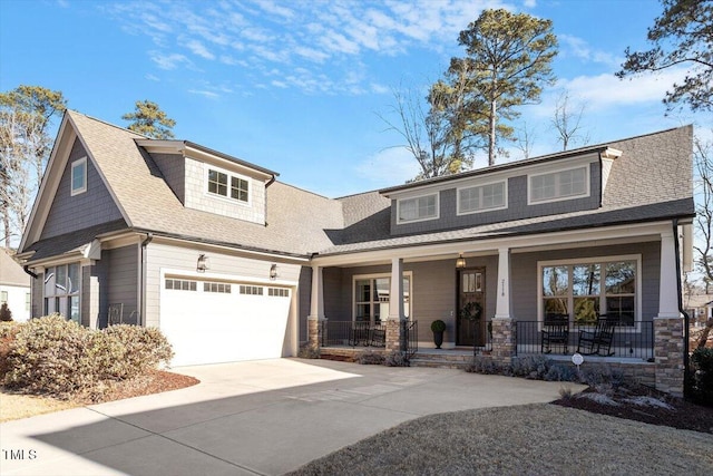 craftsman inspired home with a garage and covered porch