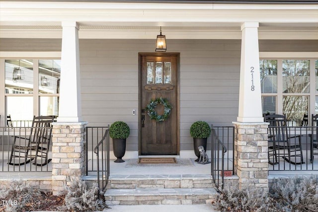 view of exterior entry with covered porch