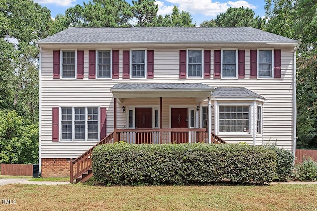 colonial inspired home with a front lawn