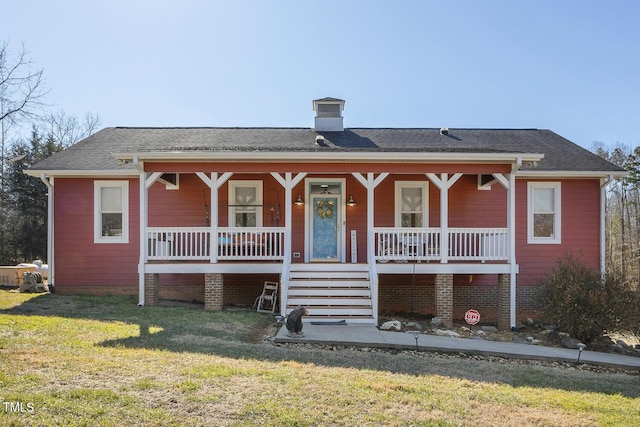 view of front of house with a porch and a front lawn