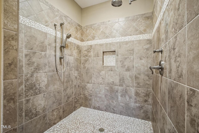 bathroom with a tile shower