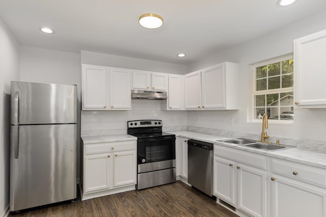 kitchen with dark hardwood / wood-style flooring, sink, stainless steel appliances, and white cabinets