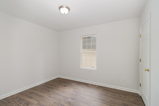 unfurnished room featuring dark hardwood / wood-style flooring