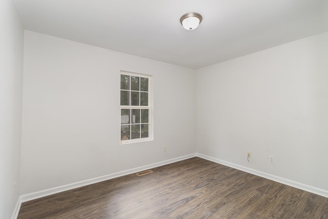 unfurnished room with dark hardwood / wood-style floors