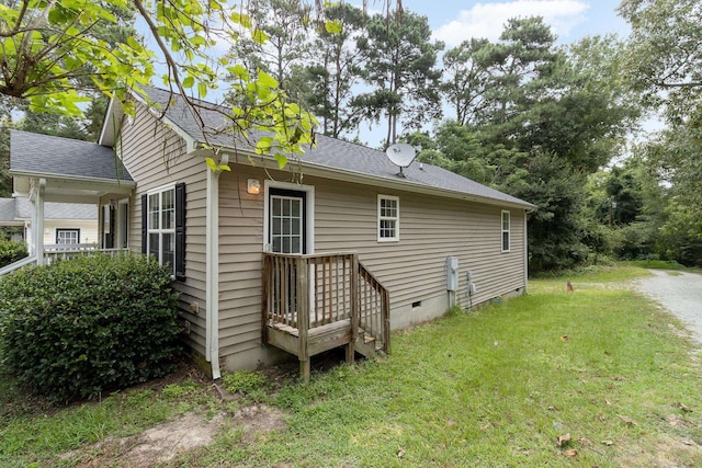 back of property featuring a lawn