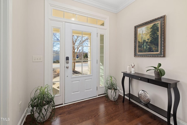 foyer featuring dark wood-type flooring, crown molding, and baseboards