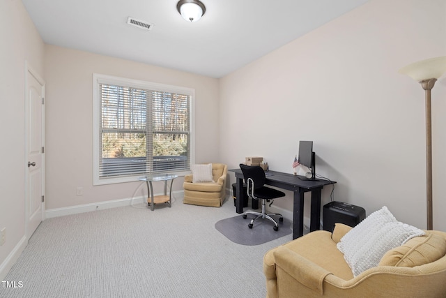 office space with carpet flooring, visible vents, and baseboards