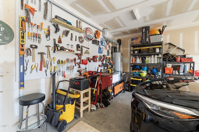 garage with a workshop area and gas water heater