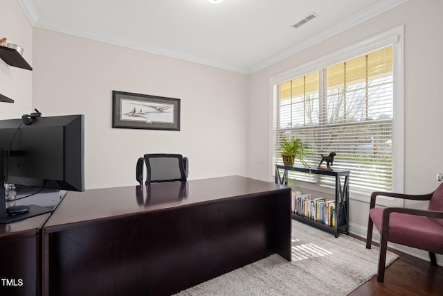 office area featuring baseboards, visible vents, crown molding, and wood finished floors