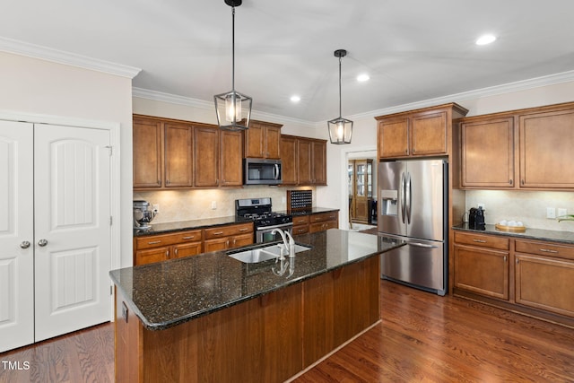 kitchen featuring brown cabinets, dark wood finished floors, crown molding, appliances with stainless steel finishes, and a sink