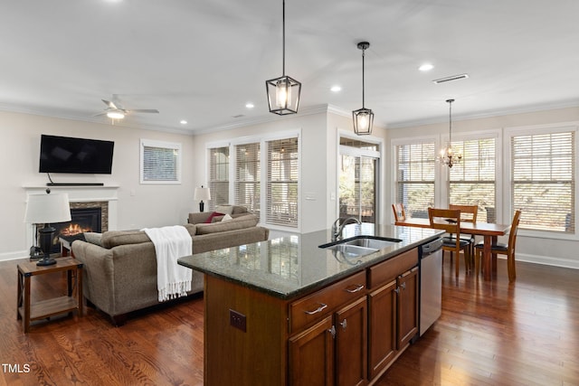 kitchen featuring visible vents, dark wood-type flooring, a sink, dark stone countertops, and dishwasher