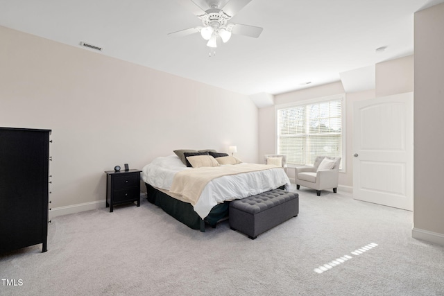 carpeted bedroom with baseboards, visible vents, and a ceiling fan