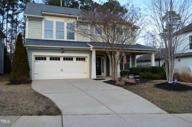 view of front facade with a porch, concrete driveway, roof with shingles, and an attached garage