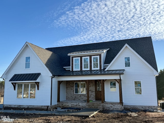 view of front facade with central air condition unit and covered porch