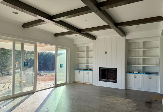 unfurnished living room featuring built in features, wood-type flooring, a large fireplace, coffered ceiling, and beam ceiling