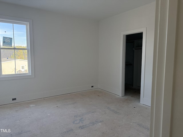 spare room with baseboards