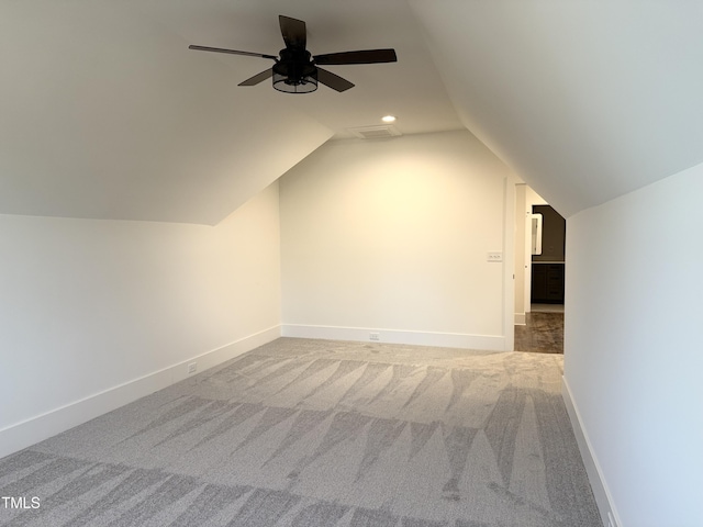 additional living space with baseboards, visible vents, lofted ceiling, ceiling fan, and carpet floors