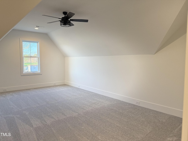 bonus room with lofted ceiling, baseboards, and carpet flooring