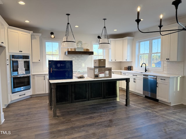 kitchen with plenty of natural light, appliances with stainless steel finishes, and light countertops