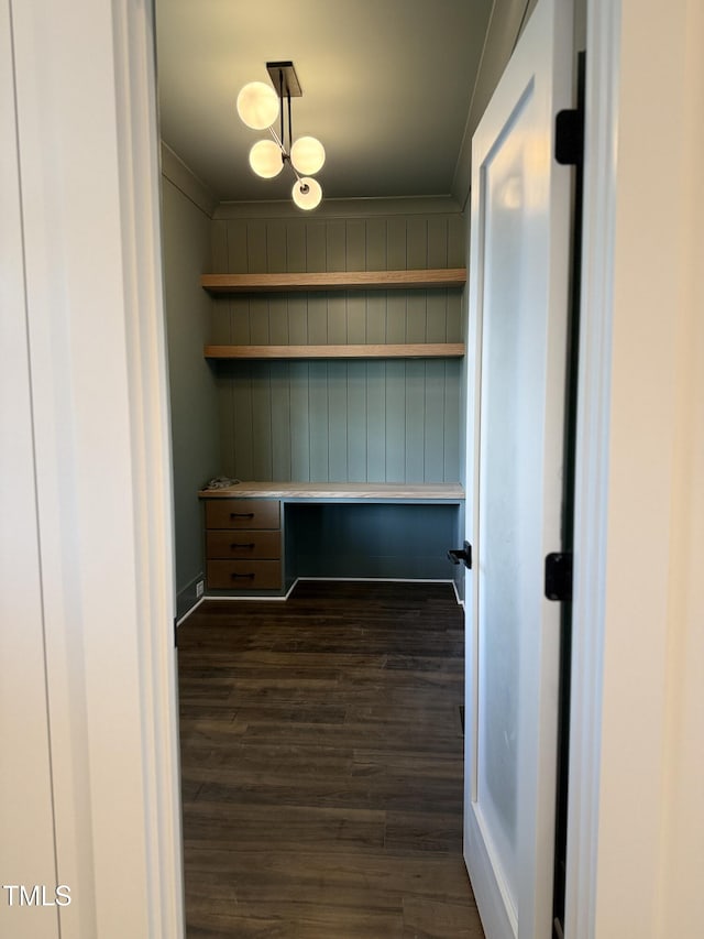 interior space with built in desk and dark wood-type flooring