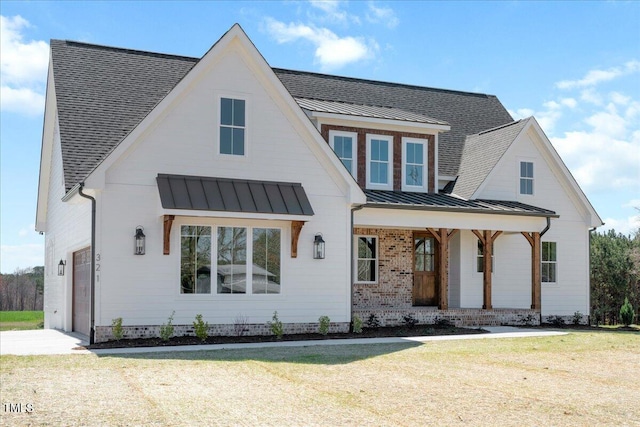 321 Bud Wall Rd, Youngsville, NC 27596 - modern inspired farmhouse with metal roof, a porch, an attached garage, and a standing seam roof