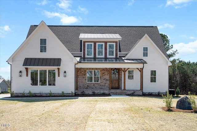 321 Bud Wall Rd, Youngsville, NC 27596 - modern farmhouse with a standing seam roof, a front yard, and metal roof
