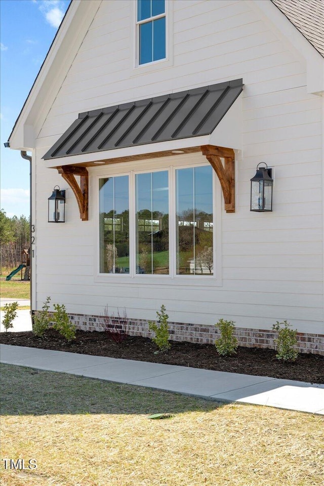 321 Bud Wall Rd, Youngsville, NC 27596 - view of side of home featuring metal roof and a standing seam roof