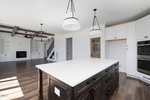 321 Bud Wall Rd, Youngsville, NC 27596 - kitchen with dark wood-type flooring, ceiling fan, open floor plan, stainless steel double oven, and white cabinetry