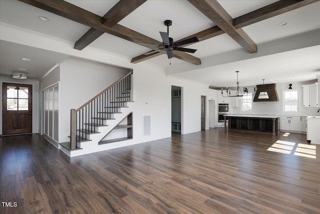 321 Bud Wall Rd, Youngsville, NC 27596 - unfurnished living room featuring beamed ceiling, visible vents, dark wood-style floors, and ceiling fan with notable chandelier