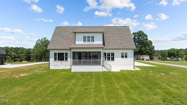 321 Bud Wall Rd, Youngsville, NC 27596 - rear view of property with a sunroom, a lawn, and roof with shingles