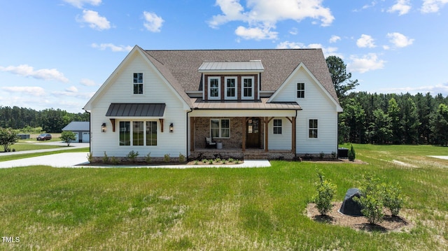 321 Bud Wall Rd, Youngsville, NC 27596 - modern inspired farmhouse featuring a standing seam roof, covered porch, a front yard, and metal roof