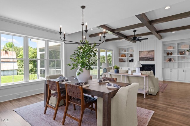 321 Bud Wall Rd, Youngsville, NC 27596 - dining room with a ceiling fan, a large fireplace, built in features, beam ceiling, and baseboards