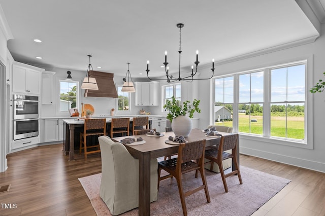 321 Bud Wall Rd, Youngsville, NC 27596 - dining space with a chandelier, recessed lighting, baseboards, wood finished floors, and crown molding