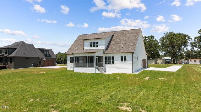 321 Bud Wall Rd, Youngsville, NC 27596 - back of property with a sunroom, a lawn, a shingled roof, and driveway