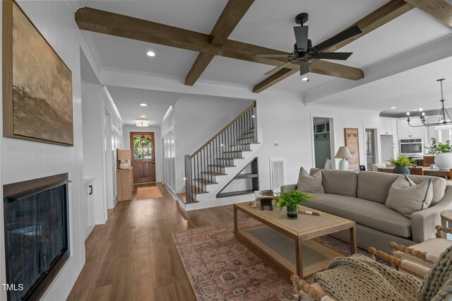 321 Bud Wall Rd, Youngsville, NC 27596 - living area with stairs, beam ceiling, a fireplace, wood finished floors, and recessed lighting