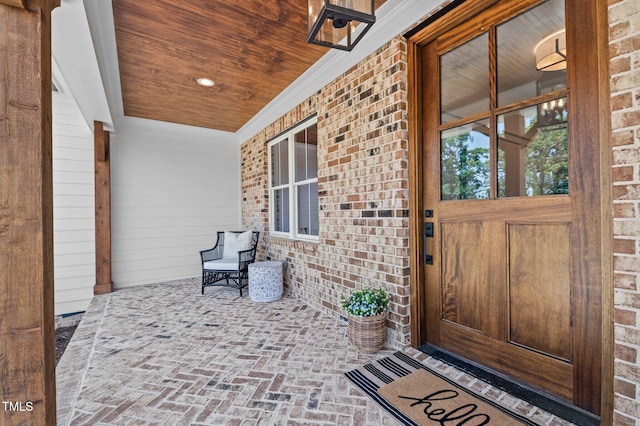 321 Bud Wall Rd, Youngsville, NC 27596 - view of exterior entry with a porch and brick siding