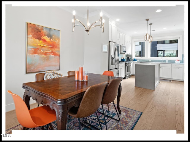 dining space with a notable chandelier and light wood-type flooring