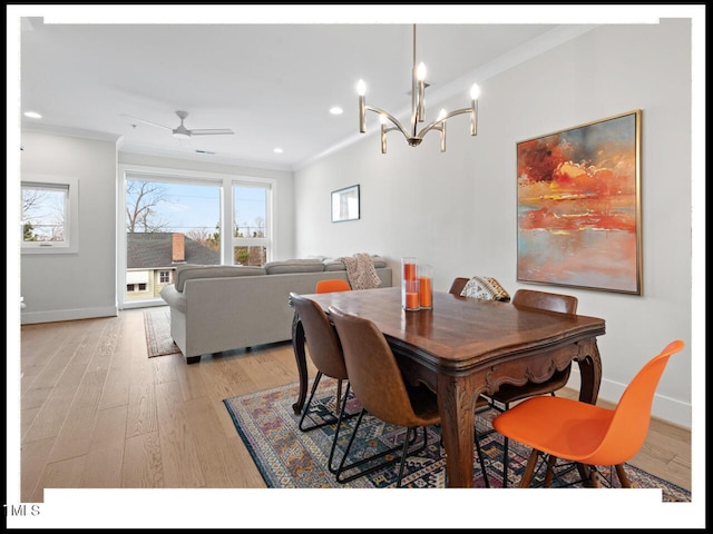 dining space featuring crown molding, ceiling fan with notable chandelier, and light wood-type flooring