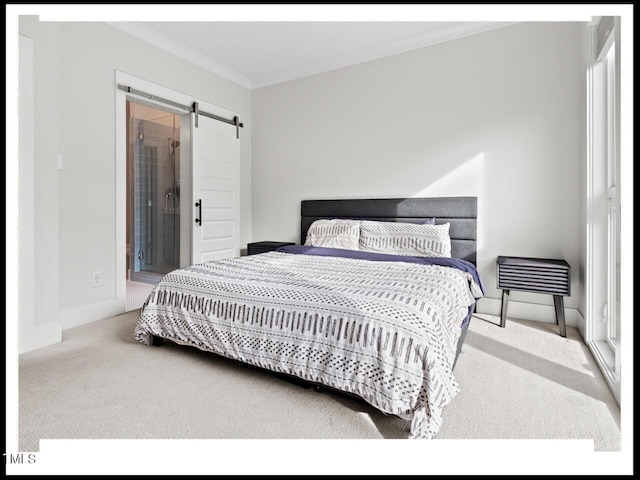 bedroom featuring crown molding, carpet floors, and a barn door