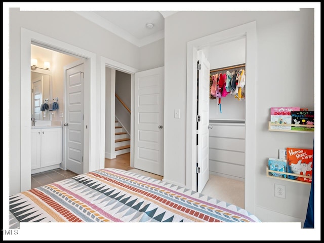 bedroom featuring a walk in closet, connected bathroom, and a closet