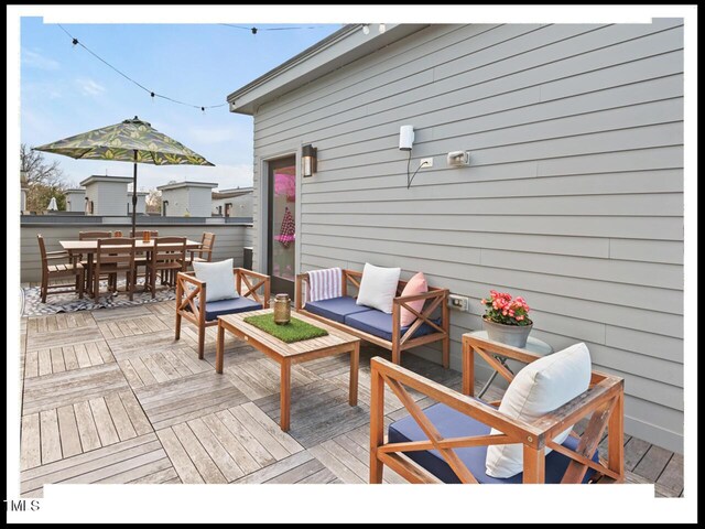 wooden terrace with an outdoor hangout area