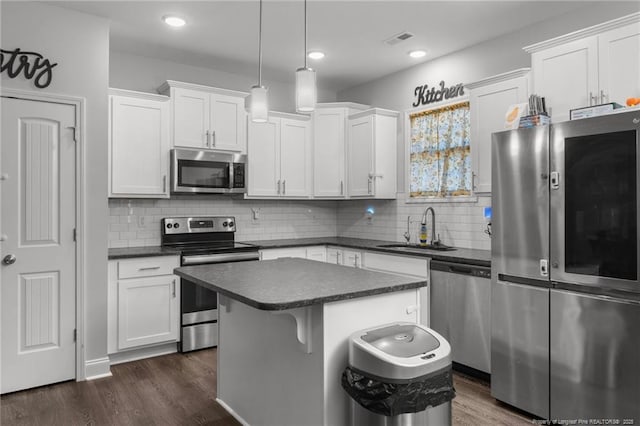 kitchen with white cabinetry, stainless steel appliances, and sink