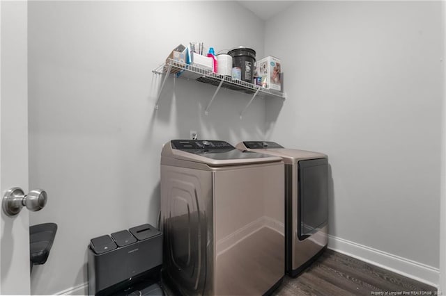 washroom with dark hardwood / wood-style floors and washer and clothes dryer