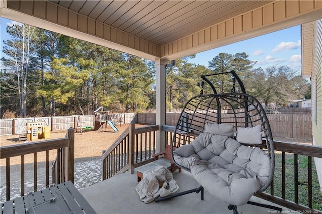 wooden deck featuring a playground