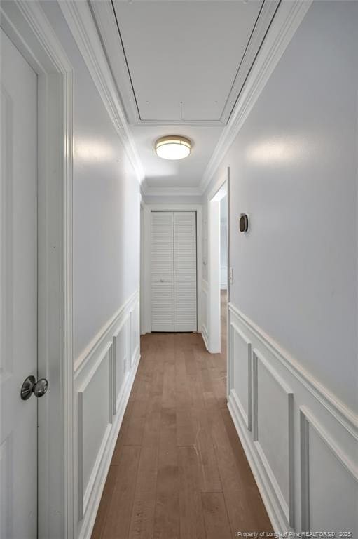 corridor with dark wood-type flooring and ornamental molding