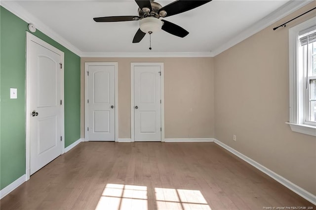 unfurnished bedroom featuring ornamental molding, ceiling fan, and light hardwood / wood-style flooring